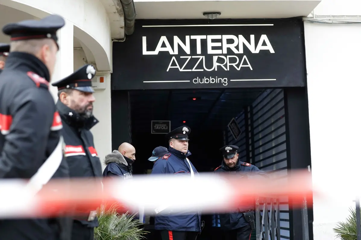 FILE -- In this Dec. 8, 2018 file photo Carabinieri officers stand in front of the disco \\\\\\'Lanterna Azzurra\\\\\\' where five young teenagers and a woman who had accompanied her daughter were killed in a stampede during a rap concert, in Corinaldo, central Italy. A court convicted six young men of involuntary manslaughter with sentences ranging from 10 years, five months to 12 years, three months for having caused the stampede. (AP Photo/Andrew Medichini) , APN