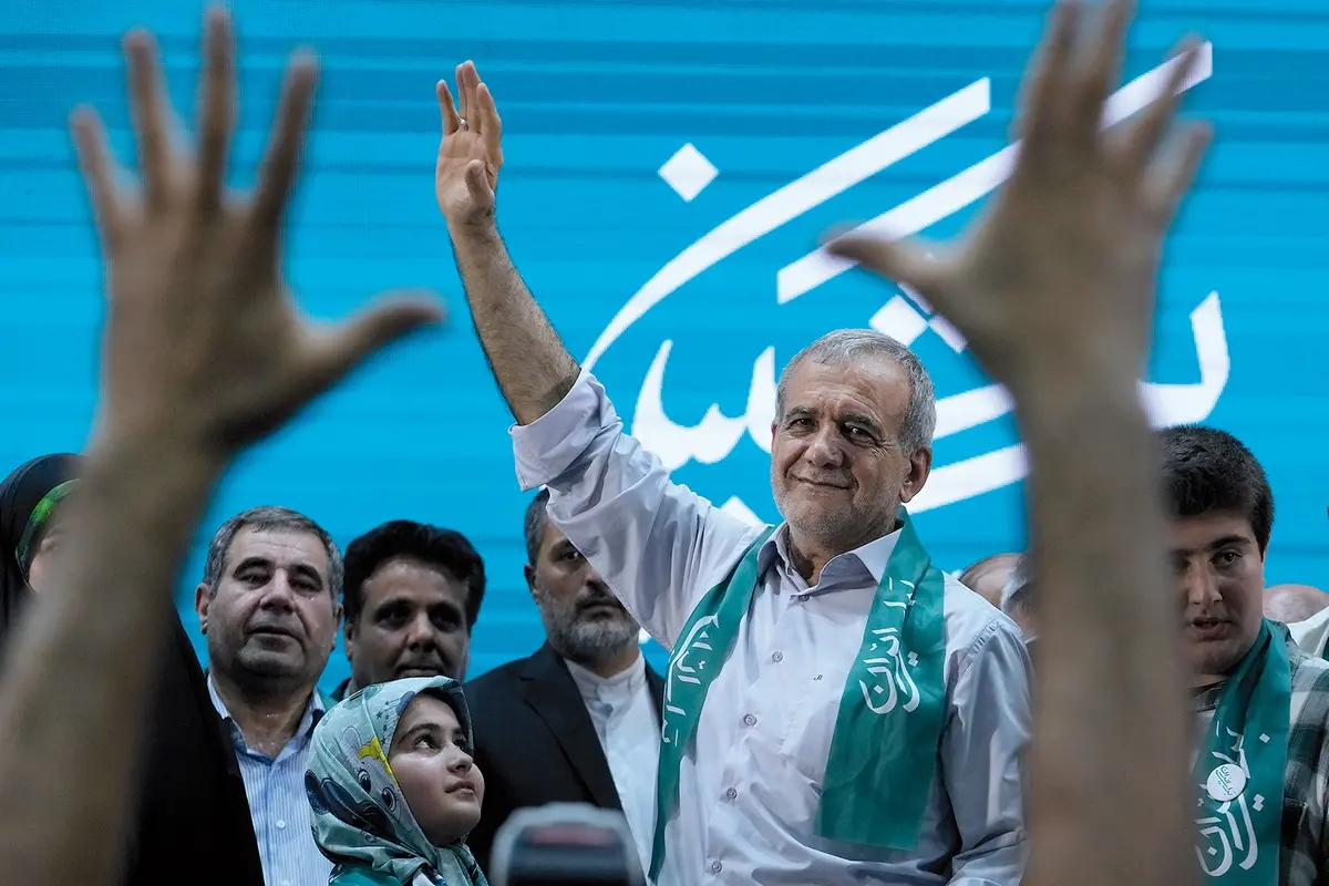 Reformist candidate for Iran\\'s June 28, presidential election Masoud Pezeshkian waves to his supporters in a campaign meeting in Tehran, Iran, Sunday, June 23, 2024. Iran\\'s Guardian Council has approved six candidates to run in the election to replace the late President Ebrahim Raisi, who was killed in a helicopter crash with seven other officials in May. (AP Photo/Vahid Salemi)