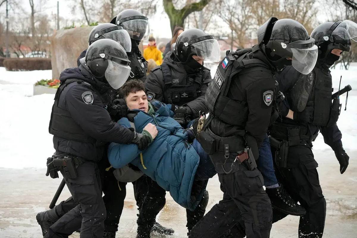 Police detain a man as he wanted to lay flowers paying their last respect to Alexei Navalny at the monument, a large boulder from the Solovetsky islands, where the first camp of the Gulag political prison system was established, in St. Petersburg, Russia on Saturday, Feb. 17, 2024. Russian authorities say that Alexei Navalny, the fiercest foe of Russian President Vladimir Putin who crusaded against official corruption and staged massive anti-Kremlin protests, died in prison. He was 47. (AP Photo) , AP