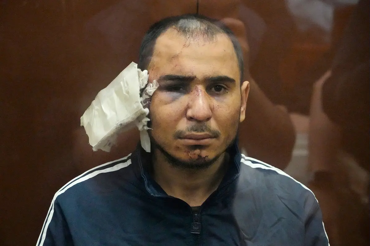 Saidakrami Murodali Rachabalizoda, a uspect in the Crocus City Hall shooting on Friday sits in a glass cage in the Basmanny District Court in Moscow, Russia, Sunday, March 24, 2024. (AP Photo/Alexander Zemlianichenko)