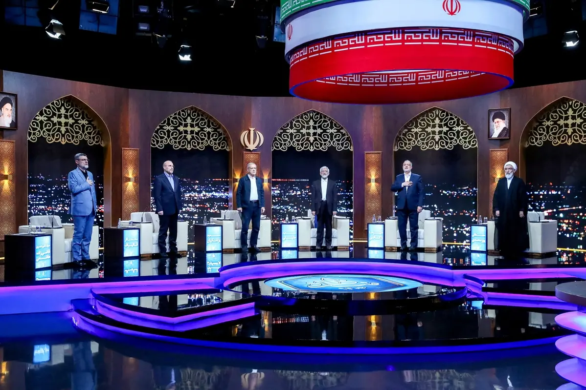 In this picture made available by Iranian state TV IRIB, presidential candidates for June 28 election from left to right; Amirhossein Ghazizadeh Hashemi, Mohammad Bagher Qalibaf, Masoud Pezeshkian, Saeed Jalili, Alireza Zakani, and Mostafa Pourmohammadi listen to the country\\'s national anthem at the start of their debate at a state-run TV studio in Tehran, Iran, Monday, June 17, 2024. (Morteza Fakhri Nezhad/IRIB via AP) , APN