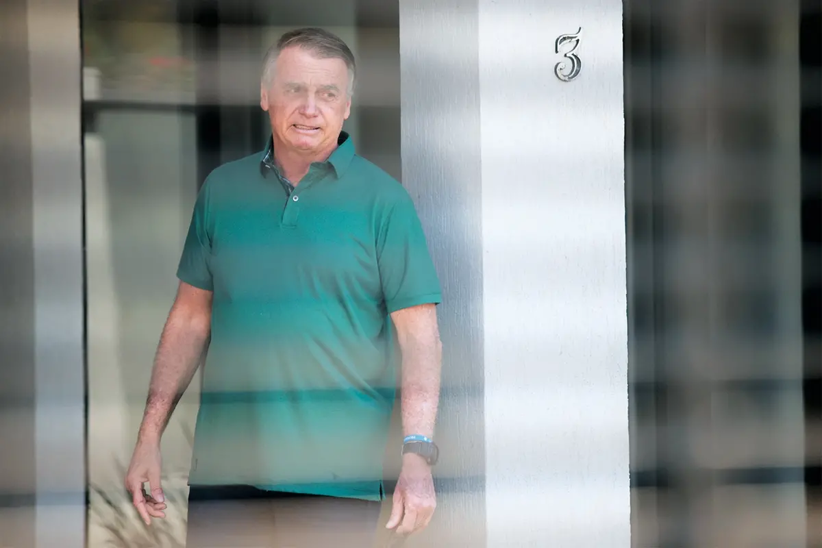 Brazil\\'s former President Jair Bolsonaro stands at the entrance of his home where he is under house arrest in Brasilia, Brazil, Thursday, Sept. 11, 2025. (AP Photo/Luis Nova) , APN