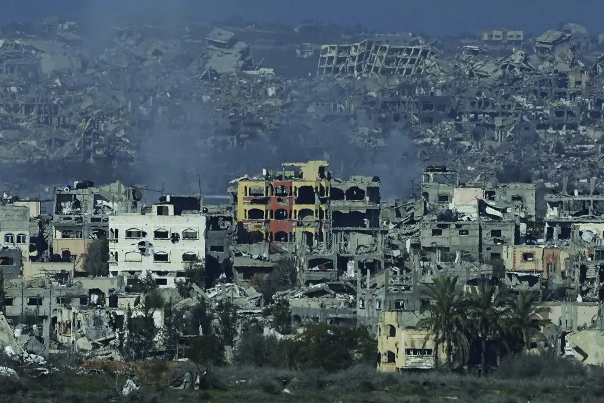 Destroyed buildings by Israeli bombardments are seen inside the Gaza Strip from southern Israel, on Tuesday, Jan. 14, 2025. (AP Photo/Tsafrir Abayov)