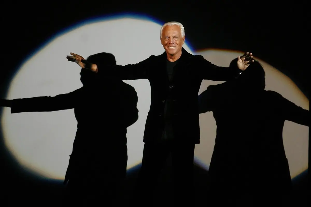 FILE - Giorgio Armani receives his share of applause after presenting his Emporio Fall-Winter 2007-2008 men\\'s fashion collection, during the Milan Men\\'s Fashion Week, in Milan, Italy, Monday, Jan. 15, 2007. (AP Photo/Luca Bruno, File) Associated Press/LaPresse , APN