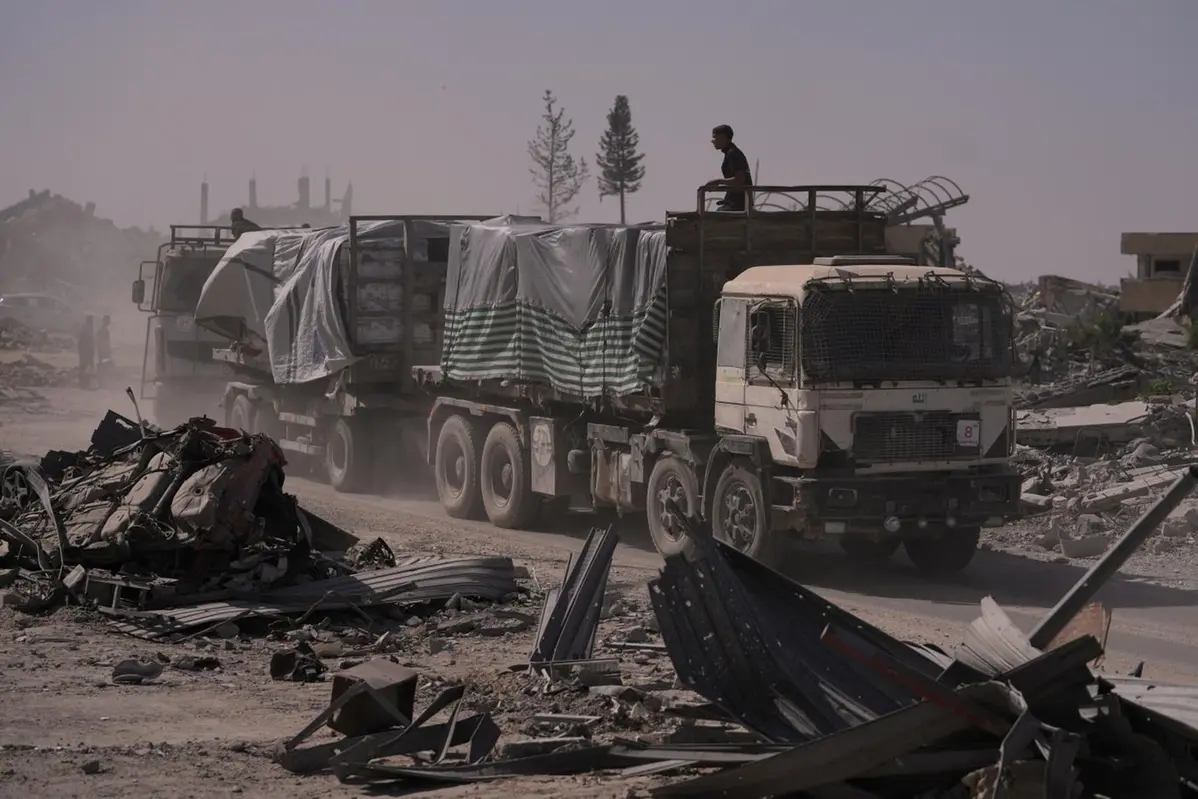 Trucks carrying humanitarian aid drive through Khan Younis, in the southern Gaza Strip, Monday, Oct. 20, 2025. (AP Photo/Jehad Alshrafi) , APN