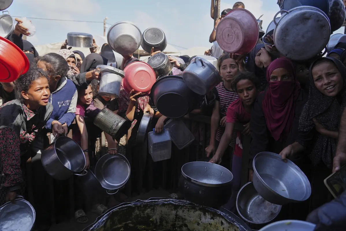 Palestinians struggle to get donated food at a community kitchen in Khan Younis, southern Gaza Strip, Friday, Sept. 19, 2025. (AP Photo/Jehad Alshrafi) Associated Press / LaPresse Only italy and spain , APN