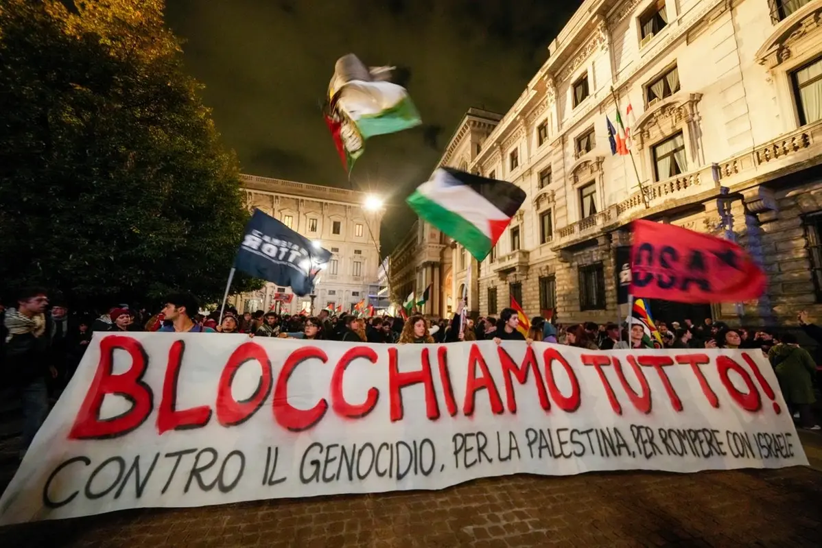 Pro-Palestinian activists march in downtown Milan late Wednesday, Oct. 1, 2025, after news that a Gaza-bound aid flotilla had been intercepted by Israeli forces in the Mediterranean Sea. Banner in Italian reads: \" Let\\'s block everything, against the genocide, pro Palestine, to break ties with Israel\".(AP Photo/Luca Bruno) , APN