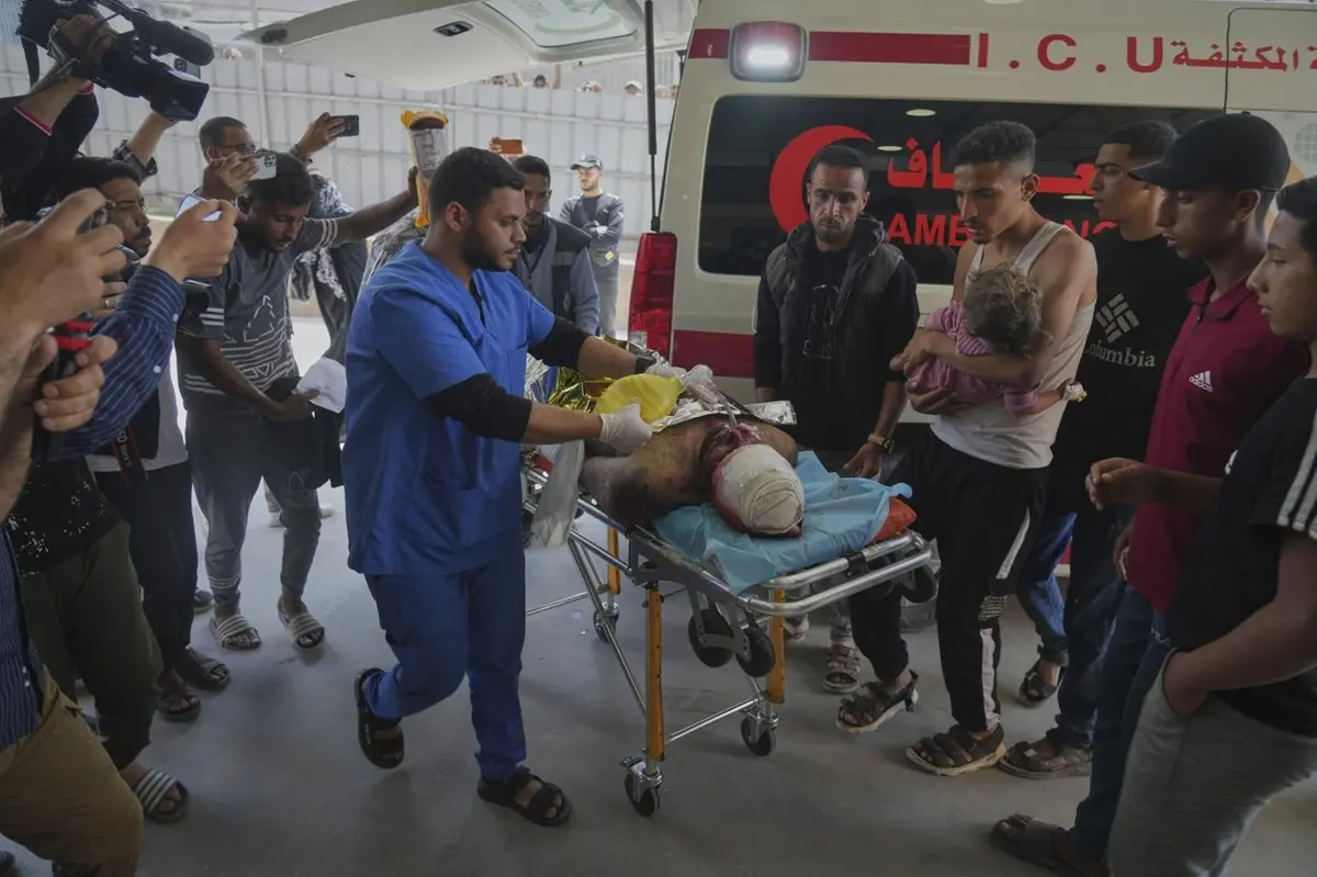 A wounded man and a child are taken into the Nasser hospital after an Israeli army strike hit a house killing at least five members of the Abu Sahloul family, in Khan Younis, in the southern Gaza Strip, Thursday, May 1, 2025. (AP Photo/Abdel Kareem Hana)