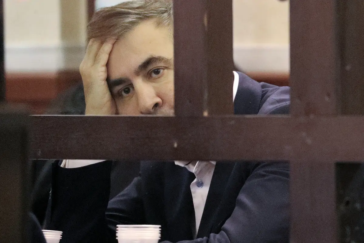 Former Georgian President Mikheil Saakashvili who was convicted in absentia of abuse of power during his presidency and arrested upon his return from exile, looks from a defendant\\'s dock during a court hearing in Tbilisi, Georgia, Thursday, Dec. 2, 2021. Saakashvili, who was president from 2008 to 2013, left Georgia after the end of his second term and was later convicted in absentia of abuse of power. He was arrested on Oct. 1 after returning to Georgia to try to bolster opposition forces in the run-up to nationwide municipal elections. (Irakli Gedenidze/Pool Photo via AP) , APN