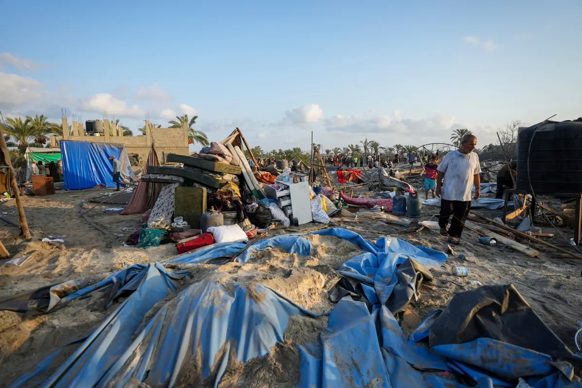 Palestinians look at the destruction after an Israeli airstrike on a crowded tent camp housing Palestinians displaced by the war in Muwasi, Gaza Strip, Tuesday, Sept. 10, 2024. An Israeli strike killed at least 40 people and wounded 60 others early Tuesday, Palestinian officials said. Israel said it targeted \\\\\"significant\\\\\" Hamas militants, allegations denied by the militant group. (AP Photo/Abdel Kareem Hana) , APN