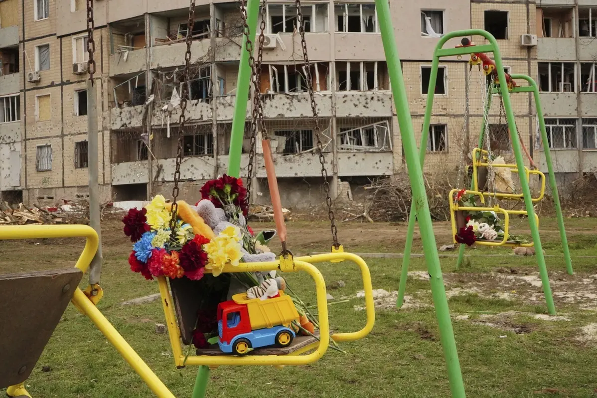 Flowers and toys left on a swing seat to commemorate victims killed in Russia\\'s missile attack on Friday, at a children play area near the damaged apartment buildings, in Kryvyi Rih, Ukraine, Saturday, April 5, 2025. (AP Photo) , APN