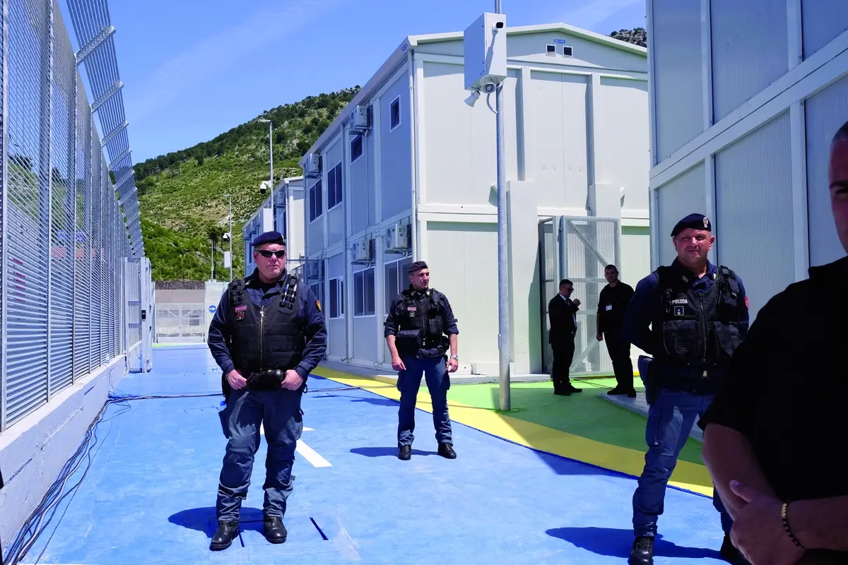 Policemen guard a reception center for migrants, at the port of Shenjin, northwestern Albania, on Wednesday, June 5, 2024. Italian Premier Giorgia Meloni is traveling to Albania Wednesday to thank the country for its willingness to host thousands of asylum seekers and to tour the sites of two migrant detention centers. (AP Photo/Vlasov Sulaj) , APN