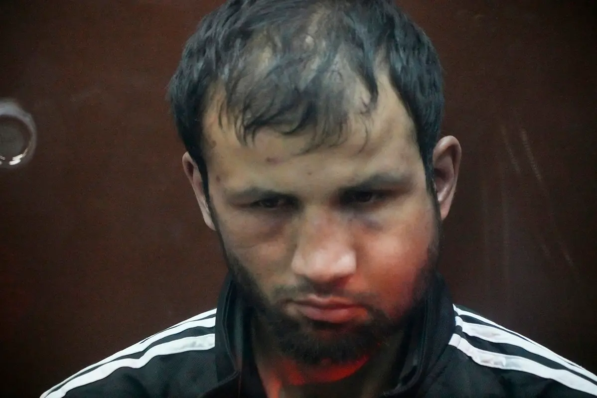 Shamsidin Fariduni, a suspect in the Crocus City Hall shooting on Friday sits in a glass cage in the Basmanny District Court in Moscow, Russia, Sunday, March 24, 2024. (AP Photo/Alexander Zemlianichenko)