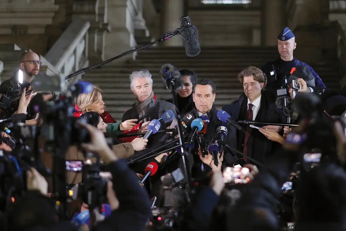 FILE - Lawyers for former European Parliament Vice-President Eva Kaili, Michalis Dimitrakopoulos, center right, and Andre Risopoulos, center left, speak with the media at the courthouse in Brussels, on Dec. 22, 2022. European Parliament President Roberta Metsola on Monday, Jan. 2, 2023 launched an urgent procedure for the waiver of immunity of two lawmakers following a request from Belgian judicial authorities investigating a major corruption scandal rocking EU politics. (AP Photo/Olivier Matthys, File) , AP