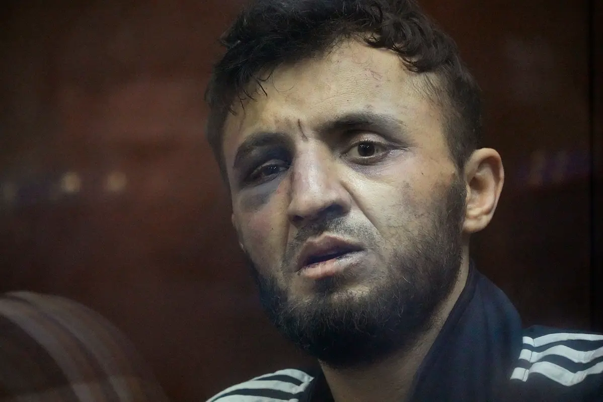 Dalerdzhon Mirzoyev, a suspect in the Crocus City Hall shooting on Friday sits in a glass cage in the Basmanny District Court in Moscow, Russia, Sunday, March 24, 2024. (AP Photo/Alexander Zemlianichenko)