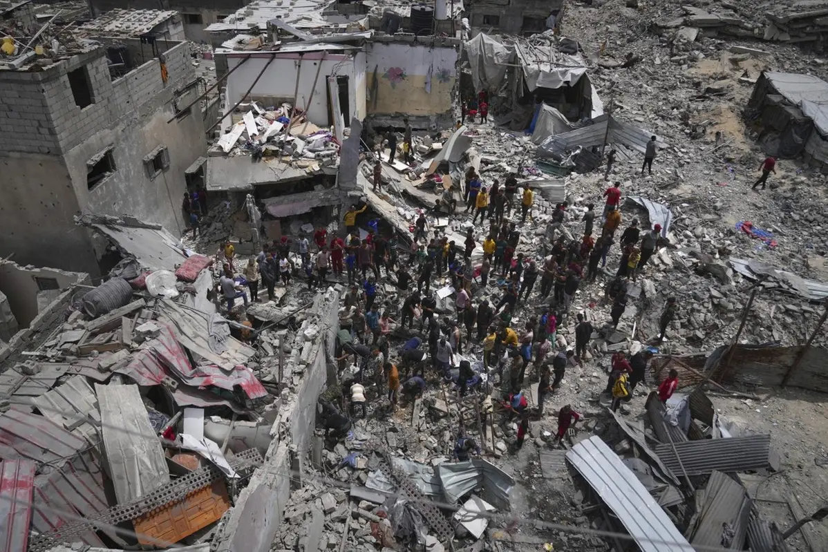 Palestinians search the rubble of a house targeted by an Israeli army strike that killed at least five people in Khan Younis, in the southern Gaza Strip, on Thursday, May 1, 2025. (AP Photo/Abdel Kareem Hana)