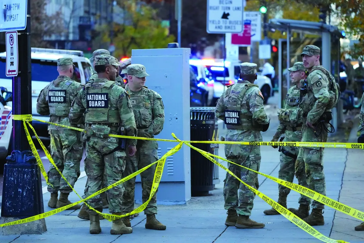 Members of the National Guard gather after reports of two National Guard soliders were shot near the White House in Washington, Wednesday, Nov. 26, 2025. (AP Photo/Mark Schiefelbein) , APN