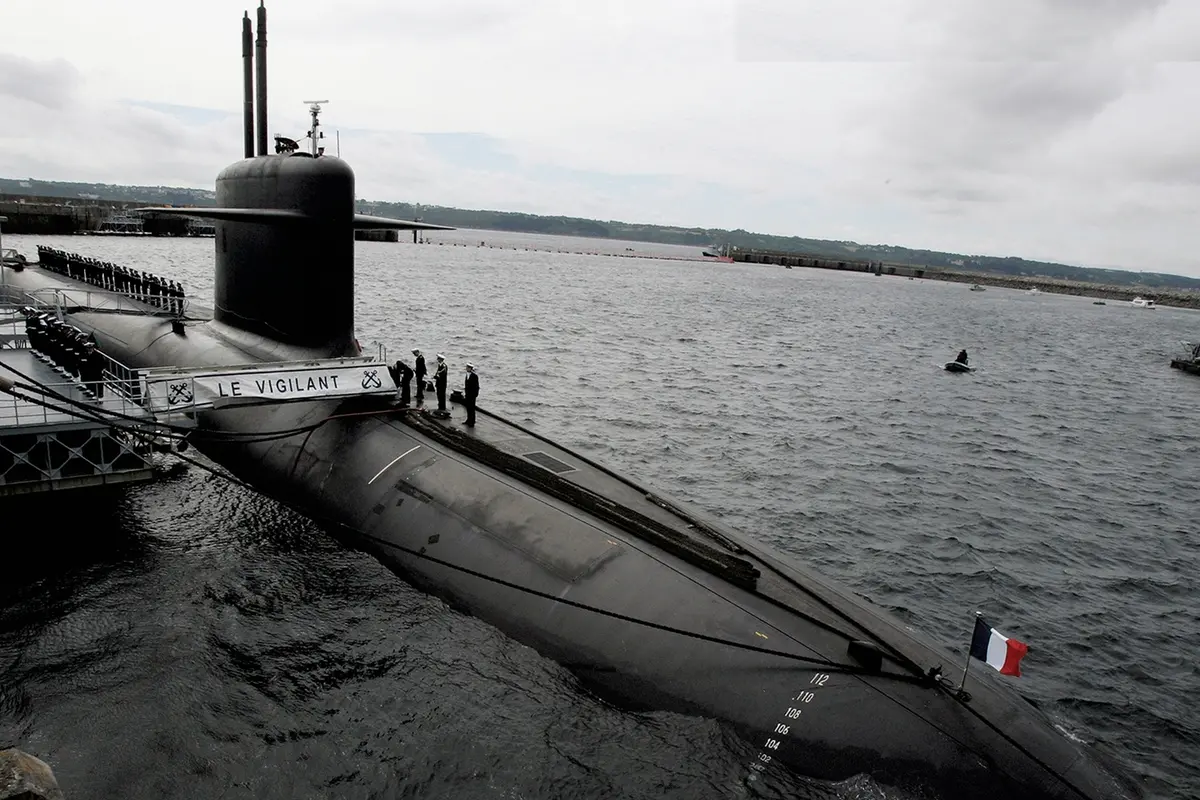 FILE - In this July 13, 2007 file photo, French Marine officers wait atop \"Le Vigilant\" nuclear submarine at L\\'Ile Longue military base, near Brest, Brittany. Stealthily cruising the ocean deeps, deliberately hiding from the world now in turmoil, the crews of nuclear-armed submarines may be among the last pockets of people anywhere who are still blissfully unaware of how the coronavirus pandemic is turning life upside down. The new coronavirus causes mild or moderate symptoms for most people, but for some, especially older adults and people with existing health problems, it can cause more severe illness or death. (AP Photo/Francois Mori, Pool, File) , AP