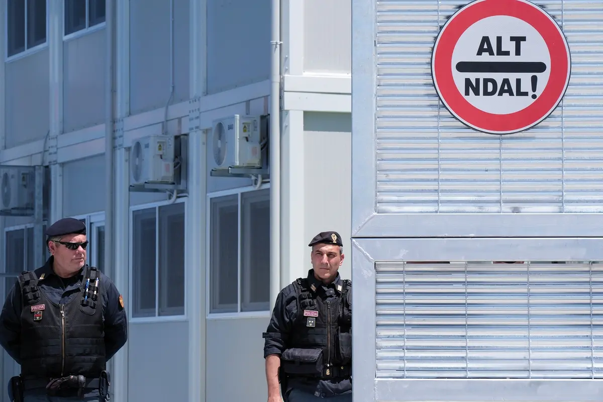 Policemen guard a reception center for migrants, at the port of Shenjin, northwestern Albania, on Wednesday, June 5, 2024. Italian Premier Giorgia Meloni is traveling to Albania Wednesday to thank the country for its willingness to host thousands of asylum seekers and to tour the sites of two migrant detention centers. (AP Photo/Vlasov Sulaj) , APN