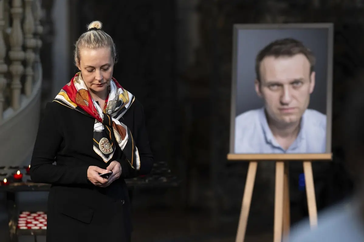 FILE -Yulia Navalnaya, widow of Russian opposition leader Alexei Navalny walks away from his picture after lighting a candle at the end of a service in St. Mary\\'s Church on the occasion of his birthday, in Berlin, June 4, 2024. (Christoph Gollnow/dpa/dpa via AP, File) , AP