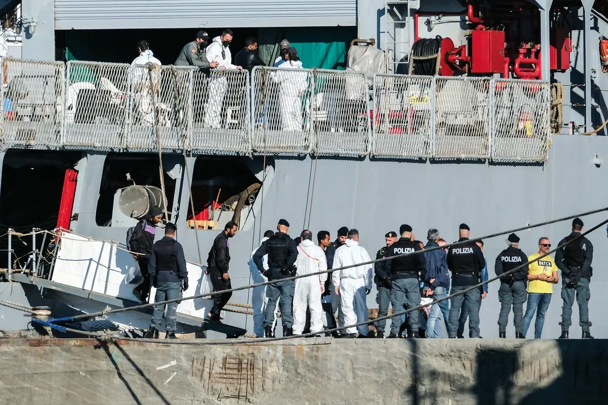 Migrants disembark from the Italian navy ship Libra at the port of Shengjin, northwestern Albania, Friday, Nov. 8, 2024, as a second group of eight migrants intercepted in international waters is processed in a reception facility despite the failure with the first group in October. (AP Photo/Vlasov Sulaj) , APN