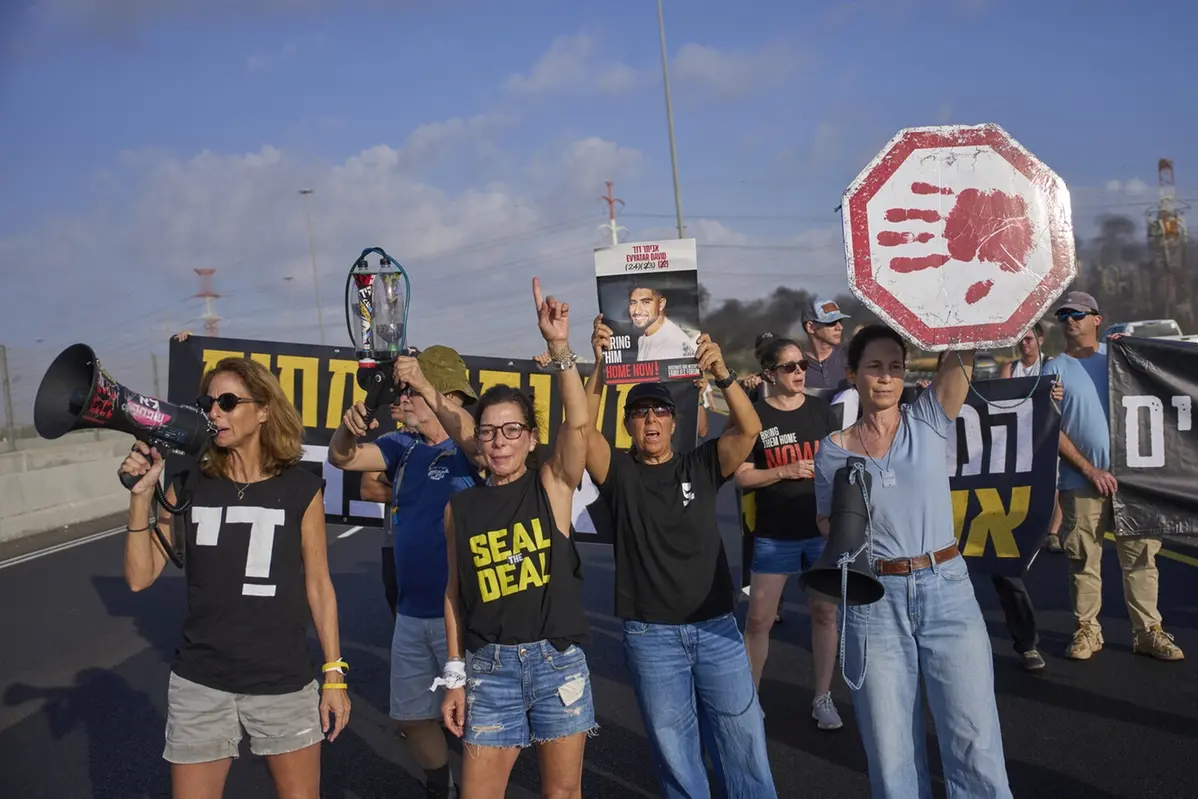 Activists block a highway during a protest demanding the immediate release of hostages held by Hamas and calling for the Israeli government to reverse its decision to take over Gaza City and other areas in the Gaza Strip, near the city of Lod, Israel, Tuesday, Aug. 26, 2025. (AP Photo/Ohad Zwigenberg) , APN