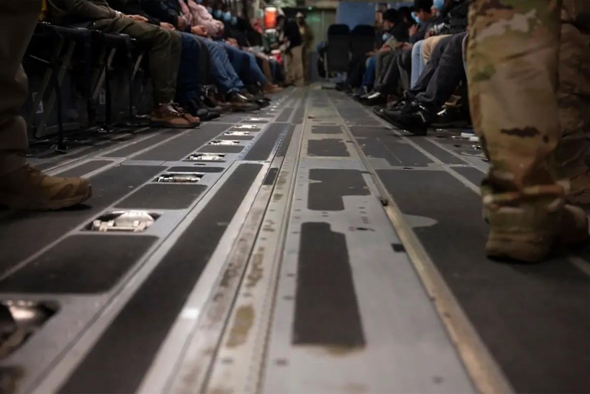 This photo provided by the U.S. Dept. of Defense, undocumented immigrants await takeoff in a A C-17 Globemaster III for a removal flight at the Tucson International Airport, Ariz., Jan. 23, 2024. (TSgt. Kimberly Nable/Dept. of Defense via AP) , APN