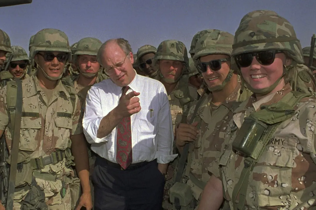 FILE - Defense Secretary Dick Cheney poses with some of the U.S. Army troops stationed in southern Iraq in this May 7, 1991 file photo. (AP Photo/Bill Haber, File) , APN